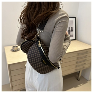Detail of coffee checkered chest bag with round coin purse and gold zipper hardware