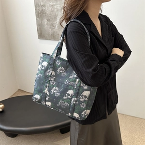 Women's gothic tote bag featuring realistic skull and floral print on lightweight material