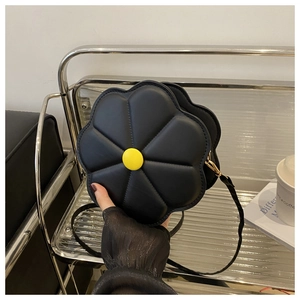 Close-up of black PU leather flower-shaped crossbody bag with a yellow center button