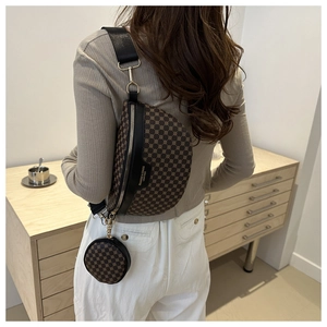 Detail of trendy brown geometric chest bag and round coin purse on a wide strap
