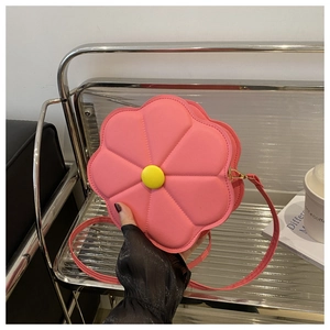 Detail of pink floral PU leather crossbody bag with yellow button and petal stitching