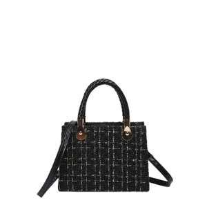 Classic black tweed crossbody bag with gold metallic accents and woven leather handle