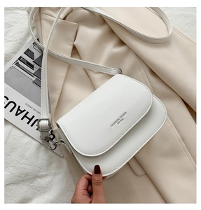 Detailed top view of white saddle crossbody bag featuring Fashion Trend printed logo