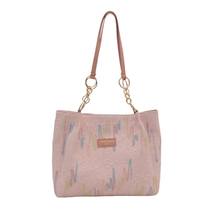 Pink PU leather tote bag with diamond quilting and colorful embroidery in front view