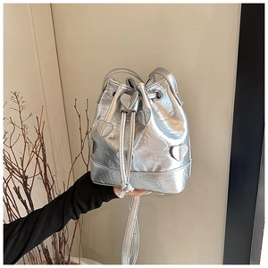 Detailed view of silver drawstring bucket bag with 3D heart-shaped applique texture