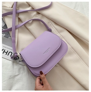 Detail of lavender leather saddle bag with adjustable strap and Fashion Trend logo