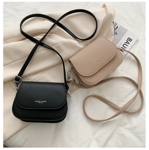 Minimalist leather saddle crossbody bag in black and beige with fashion lettering