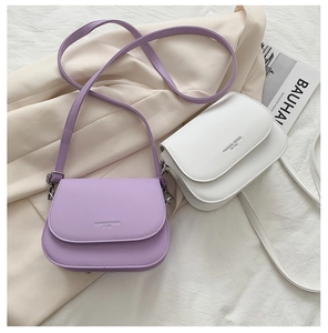 Detail of mini saddle bags in purple and white with elegant long leather shoulder straps