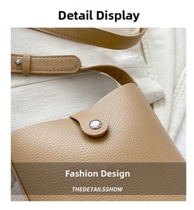Close-up of light brown lychee grain leather texture with silver metal buckle on the bag