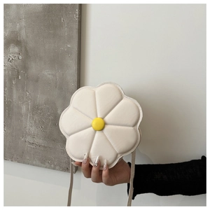 Close-up of a white flower-shaped crossbody bag with a yellow center button detail