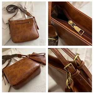 Detail of vintage brown leather bucket bag with jacquard strap and mini pouch