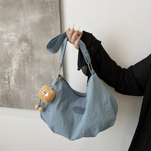 Quilted light blue hobo bag with adjustable strap and toast plush pendant