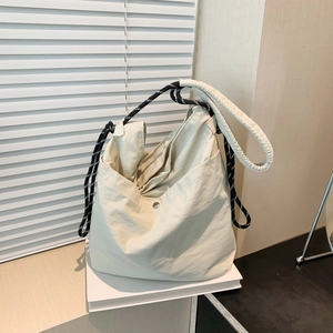 Minimalist beige nylon tote bag with stylish braided rope straps for daily commute