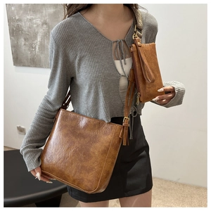 Retro brown leather bucket bag set with textured finish and golden metal details