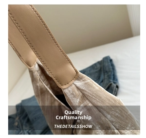 Detail of stitched leather strap on champagne velvet tote bag with refined texture