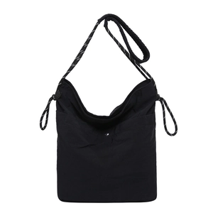 Chic black nylon crescent tote bag with striped woven strap and silver snap closure