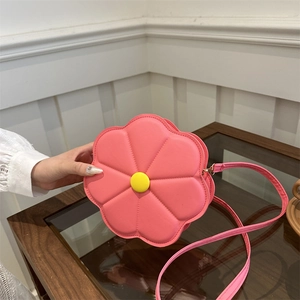 Chic pink floral shaped crossbody bag with 3D petal design and yellow center button detail