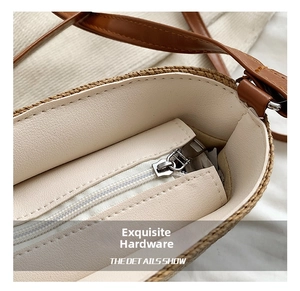 Detail showing the inner lining and silver zipper of the woven summer beach straw bag