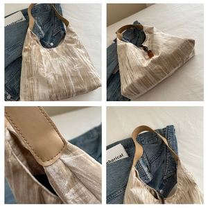 Detail shots of beige bamboo pattern velvet tote bag with amber buckle and leather strap