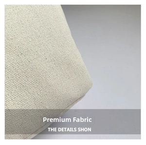 Close-up of durable off-white canvas fabric and reinforced side stitching on the tote bag