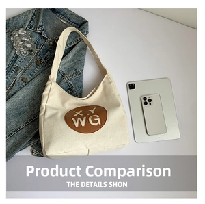 Flat lay of cream canvas tote bag with brown leather letter patch and daily essentials