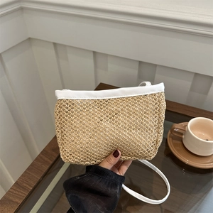 Handheld woven straw bucket bag with white leather trim and strap for summer