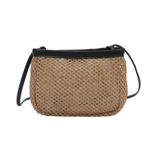 Minimalist straw woven bucket bag with black leather straps on white background