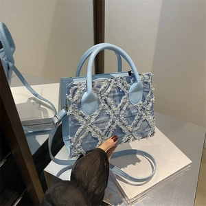 Light blue square tote bag with denim fringe detail and detachable shoulder strap