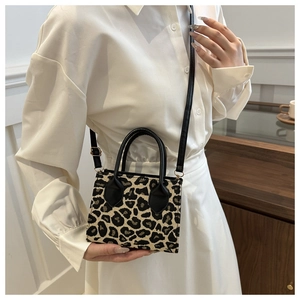 Close-up of leopard print crossbody bag showing high-quality fabric and sleek black straps
