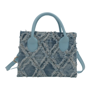 Light blue denim handbag with frayed edges and diamond quilted pattern in a square shape