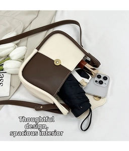Internal view of the bicolor shoulder bag showing spacious storage for daily essentials