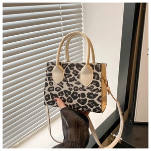 Detail of trendy leopard print jacquard small square bag with white leather contrast trim