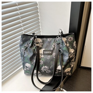 Detail of skull print tote bag with thick silver chain strap and FASHION logo tag