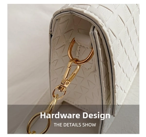 Close-up of white woven leather bag detail with elegant gold metal hook and chain hardware