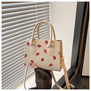 Detail of corduroy crossbody bag with vintage strawberry print and texture