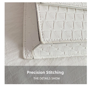 Macro detail of high-quality white faux leather with geometric texture and fine stitching