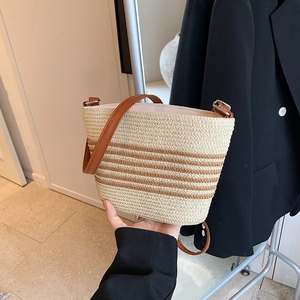 Large capacity woven straw bucket bag with brown stripes and leather shoulder straps
