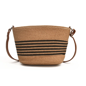 Striped straw bucket bag for summer beach holidays featuring brown leather strap