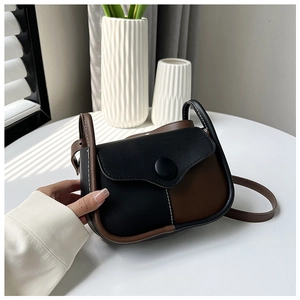 Detail of vintage square crossbody bag with contrast stitching and decorative round button