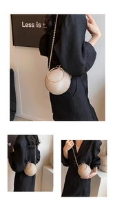 Detail of a sparkling spherical mini evening bag with rhinestone ring handle and chain