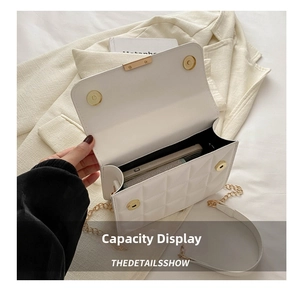 Capacity display of white quilted crossbody bag with gold chain and interior phone space