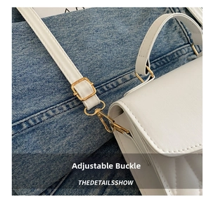 Close-up of white quilted handbag featuring gold adjustable buckle and leather strap