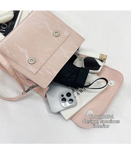 Internal view of pink marble-textured shoulder bag showing its large capacity and double magnetic closure