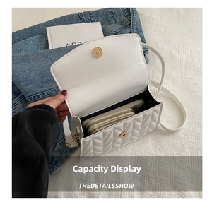 Internal view of white quilted crossbody bag showing space for wallet and phone