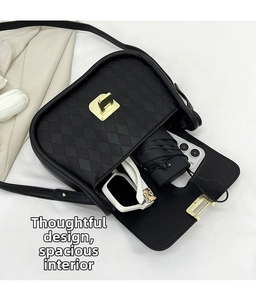 Internal view of a black quilted crossbody bag showing space for phone and umbrella