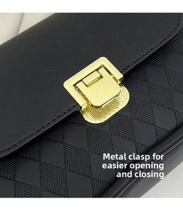 Close-up of black leather bag featuring a gold square lock and quilted texture
