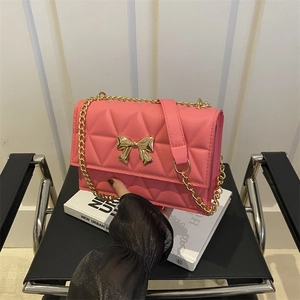 Pink quilted shoulder bag with gold butterfly buckle and metal chain strap for women