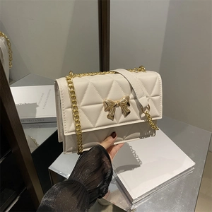 Quilted beige crossbody bag with gold butterfly buckle and chain strap for women
