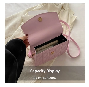Detailed interior view of pink quilted handbag showing storage capacity for phone and wallet