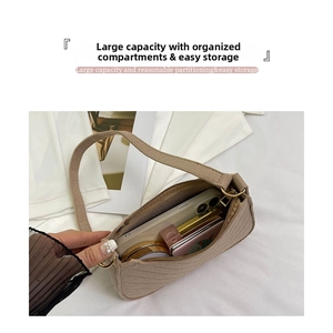 Detail of khaki quilted shoulder bag showing interior space for phone and makeup